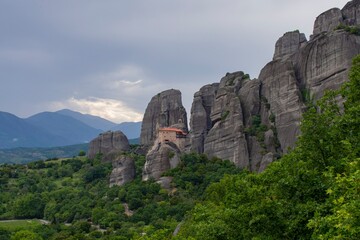 Meteora monasteries on the tops of rocks in the mountains. Interesting shaped rock formations in Greece. Beautiful mountain landscape.