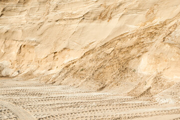 Excavator wheel marks in a sand quarry
