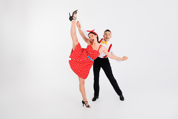 Full body photo of two partners dancing contest raise stretch leg isolated on white color background