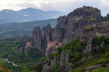 Meteora monasteries on the tops of rocks in the mountains. Interesting shaped rock formations in Greece. Beautiful mountain landscape.