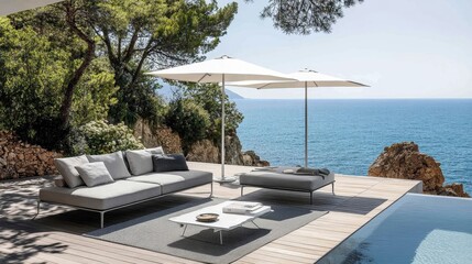 Fototapeta premium Modern outdoor lounge area overlooking the ocean with umbrellas and a pool.