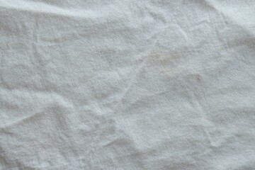 Grey textile napkin in white color as background. Folded decorative kitchen cotton towel