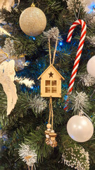 Green fir tree with globes and a small house as background
