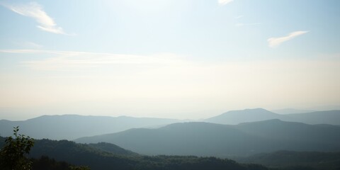 Fototapeta premium Serene Panorama of Rolling Hills Under a Pale Sky