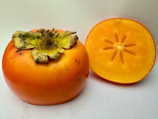 ripe persimmon fruit on a white isolated background