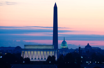 Washington DC cityscape in a foggy sunrise with major city monuments including the Lincoln Memorial and Washington Monument and the Capitol Building