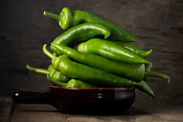 Fresh raw green peppers on table, genuine food ingredients, agricultural concept
