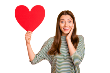 Photo of gorgeous cool girl rejoicing about having been gifted big red heart for valentine day while isolated with yellow background