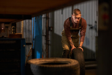 Mechanic working with tires in tire service