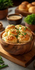 Freshly baked biscuits topped with herbs in a wooden bowl.