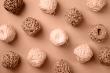 Mocha Mousse - color of the year 2025. yarn wool on brown backdrop, top view flat lay