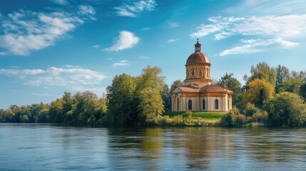 Fototapeta na wymiar Historic rotunda chapel by the river with vibrant greenery and blue sky creating a serene landscape perfect for nature and architecture themes