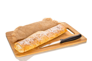 One cherry strudel with ceramic dishes on a bamboo kitchen board, close-up, isolated on a white background.