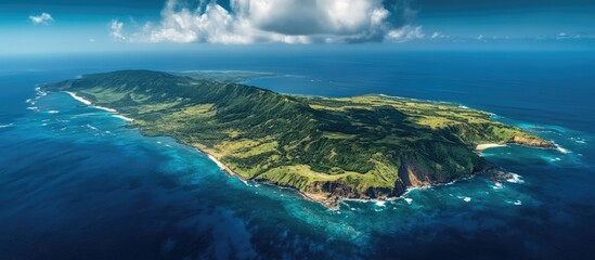 Aerial view of lush green island surrounded by vibrant blue ocean showcasing rugged terrains and stunning natural landscapes