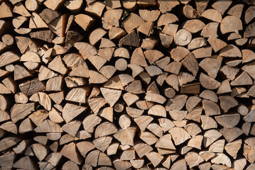 Stack of hard wood from trees used to make charcoal or burned in a fireplace