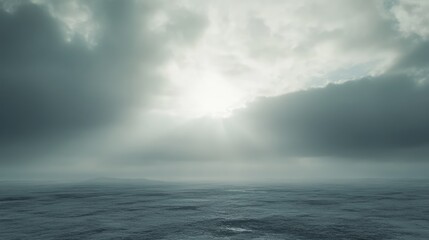 Serene overcast sky with thick clouds and a glimpse of sunlight illuminating a tranquil ocean scene.
