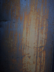 A rusty metal surface with a blue and brown color