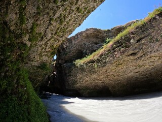 The Aksu River with white water, rocky cliffs and a strip of blue sky