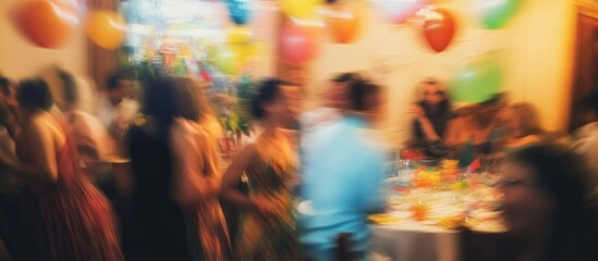 Celebration atmosphere at a birthday party with festive decorations and blurred group of people enjoying the joyful occasion