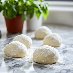 Fototapeta premium Fresh Dough Balls on a Marble Countertop with Green Herb Plant in Background
