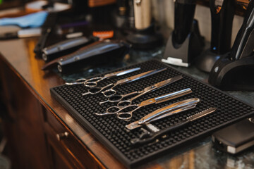 A barber shop with scissors and other tools on a counter