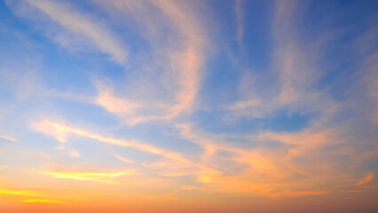 Sunset sky background in the evening with yellow sunlight cloud on blue dusk sky