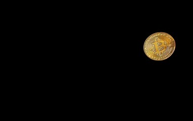 A golden Bitcoin coin placed in the lower-left corner of a black background, creating space for text in the upper-right. 