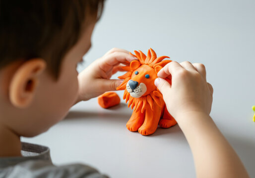 Child creating a colorful lion figure using modeling clay at a table in a well-lit indoor space