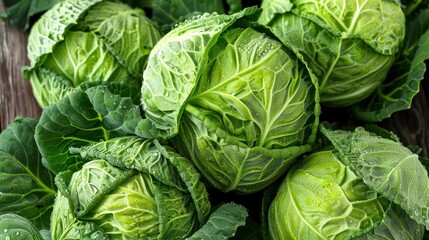 Fresh green cabbages on wooden surface.