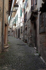 Fototapeta premium View of narrow medieval street with ancient buildings in Bracciano, Italy.