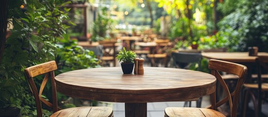 Cozy rustic wooden chair and table set in a lush outdoor restaurant ideal for relaxed dining surrounded by nature's beauty.