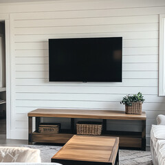 Modern living room with TV mounted on shiplap wall, featuring wooden TV stand and decorative plants. space is bright and inviting, perfect for relaxation