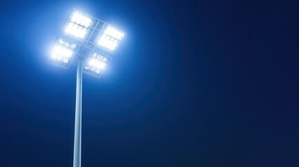Bright Stadium Floodlight Illuminating Dark Night Sky for Sports Events