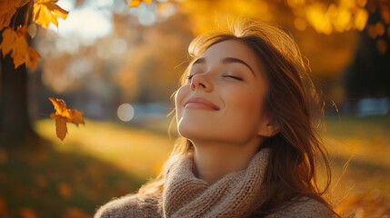 Fototapeta premium Woman enjoying a serene autumn day with golden leaves in the park. 