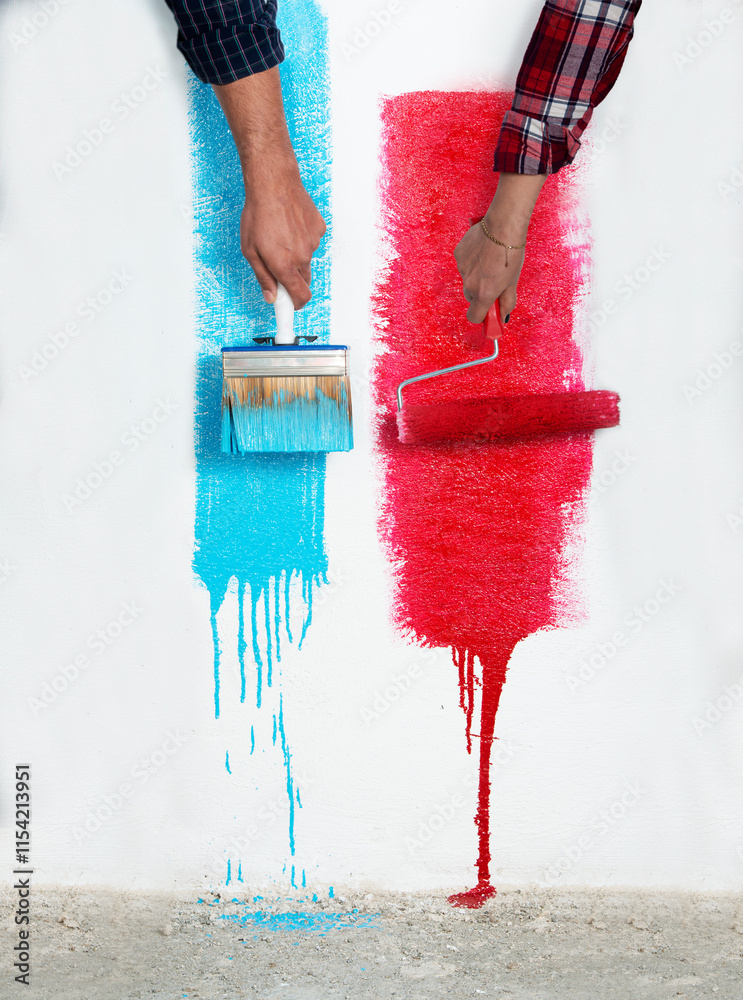 Wall mural A girl’s red roller brush and a boy’s blue paintbrush side by side in front of a textured wall, perfect for DIY and home improvement visuals.