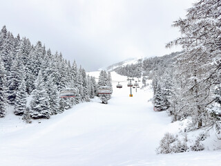 ski lift in a snowy winter landscape. winter snowy pine tree forest. winter sports. winter background