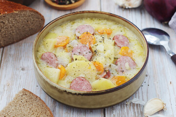 A bowl with traditional German potato soup with sausages