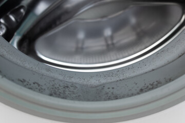 Closeup image of dirty moldy washing machine, mold in the cuff, abstract metallic texture background