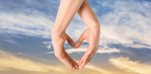 Woman making heart with her hands on white background