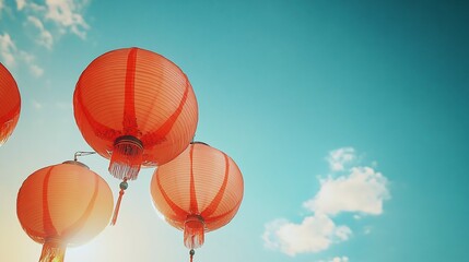 Golden hour photography of red Chinese lanterns glowing against clear blue sky creating a beautiful color contrast