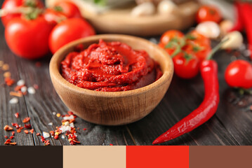 Bowl with red sauce and vegetables on table