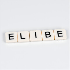 The concept of eligible represented by black and white plastic letter cubes