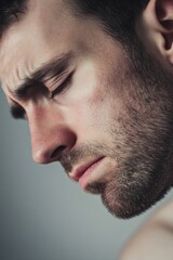 Obraz premium A close-up shot of a man's face with his eyes shut, expression serene