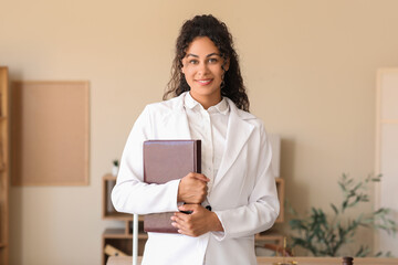 Female African-American lawyer with notebook in office