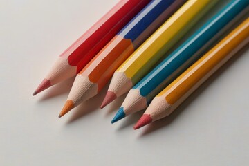 several colored pencils lined up in a row on a white surface