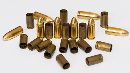 photo of a black pistol and bullets on a black background