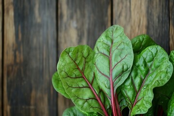 Fresh Swiss Chard Leaves with Vibrant Green Color and Red Stems on Rustic Wooden Background for Healthy Eating, Cooking, Nutrition, and Organic Lifestyle
