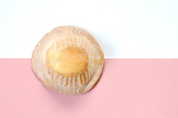 Sweet bread over pink and white background.