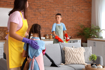 Cute little children helping their mother with cleaning routine at home