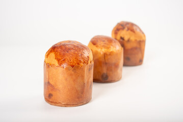 Mini panettone, mini panettone placed on a white surface with a white background, selective focus.